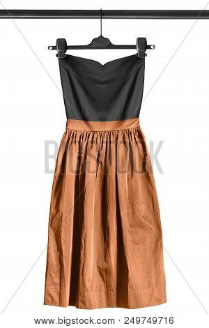 Silk Strapless Dress With Flared Brown Skirt Hanging On Clothes Rack Isolated Over White