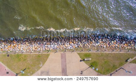 Aerial Top View Of Sea Waves Hitting Rocks On The Beach At Esplanade In Sipitang Town,sabah Borneo,m