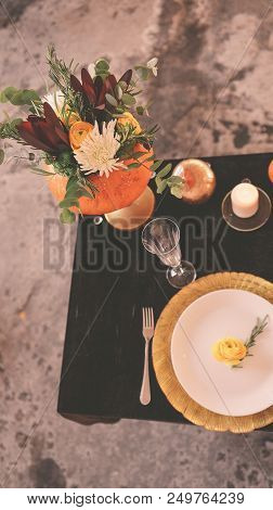 Beautiful Autumn Floral Bouquet In A Pumpkin Vase. Preparing For Halloween. Table Setting For The We
