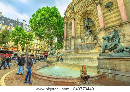 Paris, France - July 1, 2017: Clochard And Tourists In Place Saint-michel And Monumental Fontaine Sa