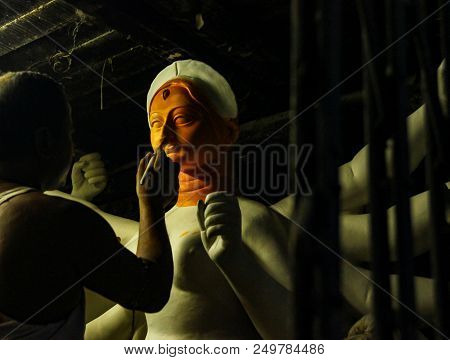 Kumartuli,west Bengal, India, July 2018.an Clay Scuplture Artist Working On A Clay Idol Of Goddess D