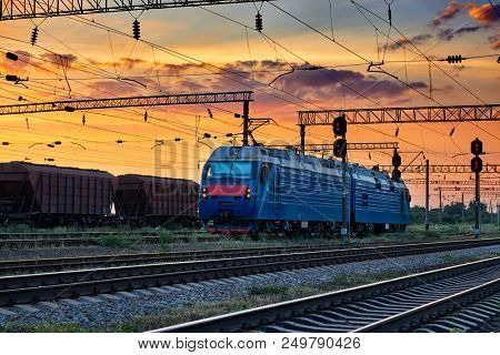trains and wagons, railroad infrastructure, beautiful sunset and colorful sky, transportation and industrial concept
