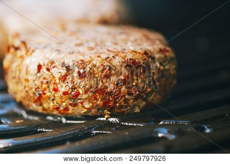 lamb burgers spiced by mint and lamb rub on bbq grill with flame