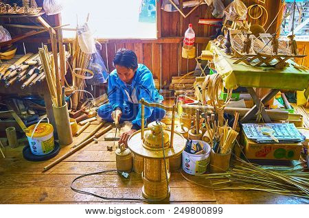 Inpawkhon, Myanmar - February 18, 2018: The Burmese Worker Produces Traditional Bamboo Souvenirs In 
