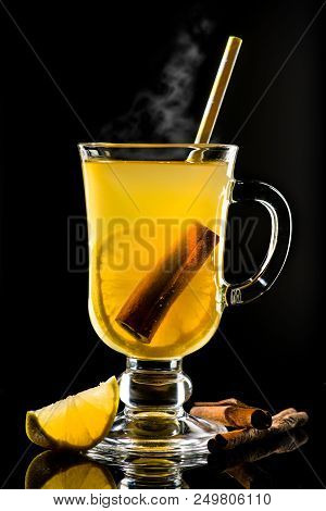 Hot Grog With Lemon, Cinnamom Stick And Honey With Steam On Dark Background
