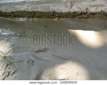 Background Of Solidifying Wet Cement On The Ground. Pouring Concrete Floor - Gray Texture