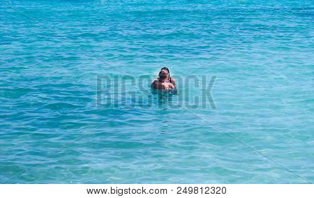 A Couple Hugging And Kissing In The  Caribbean Sea