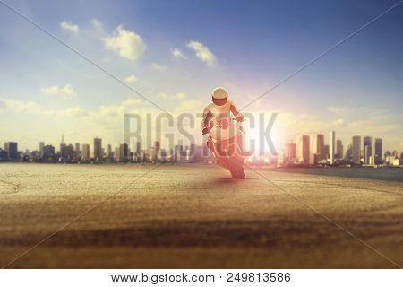 Man Riding Big Motorcycle On Sharp Curve Against City Building Scene