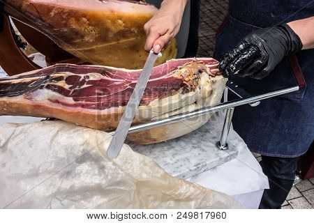 Prosciutto. Traditional Spanish Ham On Close Up. Slicing Hamon Iberic. Waiter Is Slicing Jamon Prosc