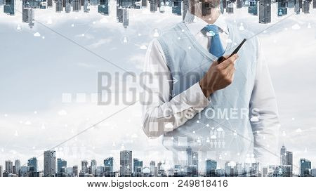 Double Exposure Of Confident And Young Businessman In Smart-casual Wear Smoking Pipe And Modern City