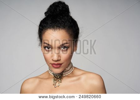 Beauty Closeup Portrait Of Beautiful Mixed Race Woman Wearing Chocker Posing, Isolated On Gray Backg