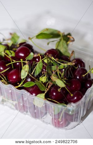 Close Up Of Red Cherries In Plastic Containers