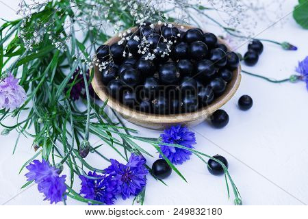 Berries Of A Tasty, Large Black Currant On A Table In A Small Plate