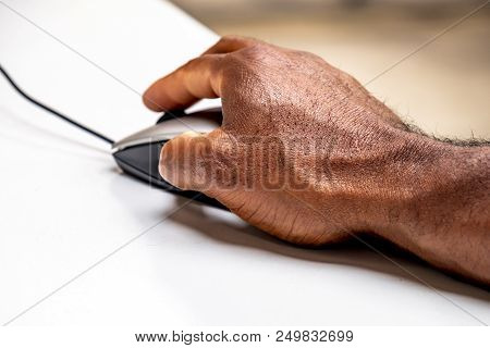African Man Using Mouse To Control The Computer.