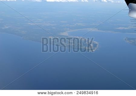 Aerial view of Windmills for electric power production on the seashore. Baltic Sea. View from the airliner of Nordic Tallinn - Oslo.June 13,2018. Tallinn, Estonia