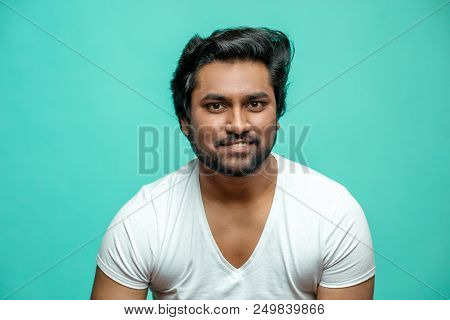 Close Up Portrait Of Cunning Indian Male Pretending That He Is Smiling.hindoo Guy Is Smiling To Show