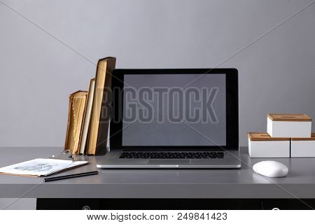 Workspace With Computer And Stack Of Papres In Office .