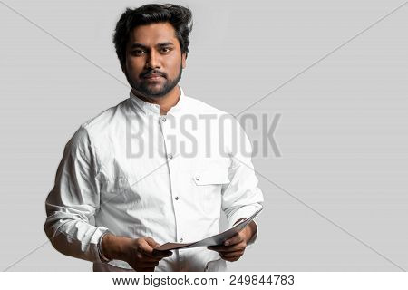 Gifted Indian Docor Looking At Camera While Working At The Hospital.copy Space. Medico In White Gown