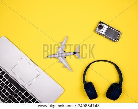 Travel Concept Displaying Airplane, Camera And Headphones. Book Your Ticket Now.