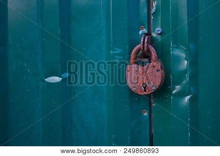 Photo Of Locked Metal Doors And Rust Keylock