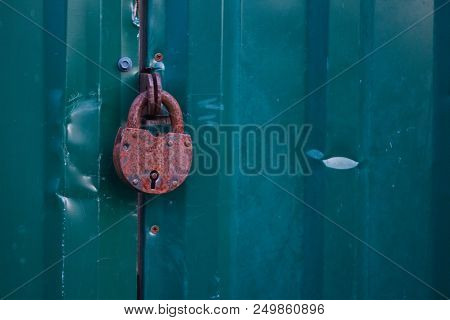 Photo Of Locked Metal Doors And Rust Keylock