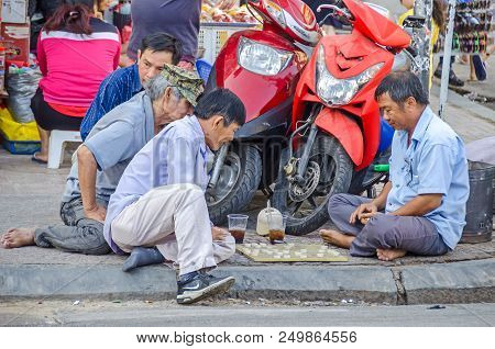 Ho Chi Minh City, Vietnam - 4 April, 2018: Street Scene - Men Playing Traditional Board Game At The 