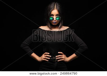 Portrait Of Cool Crazy Brunette Fashionable Girl In Sunglasses, Casual Hairdo On Black Background. W