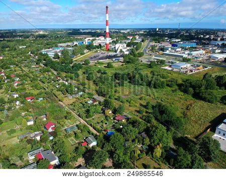 Heating Plant With High Chimney In City, Close To The Allotment Gardens, Aerial View.