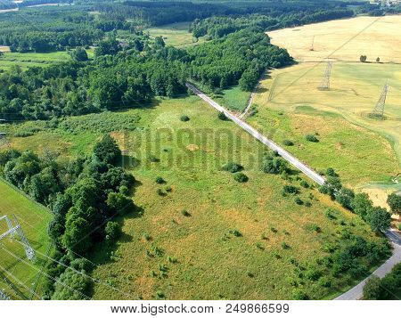 Aerial View On Landscape With Forest, Meadow, Wheat Fields, Road ,energetic Towers And Cable.