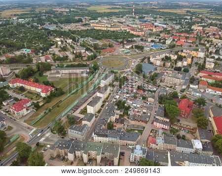 Aerial View On A Cityscape With Buildings, Park And Roundabout.