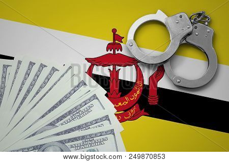 Brunei Darussalam Flag  With Handcuffs And A Bundle Of Dollars. The Concept Of Illegal Banking Opera