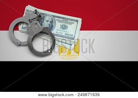 Egypt Flag  With Handcuffs And A Bundle Of Dollars. The Concept Of Breaking The Law And Thieves Crim