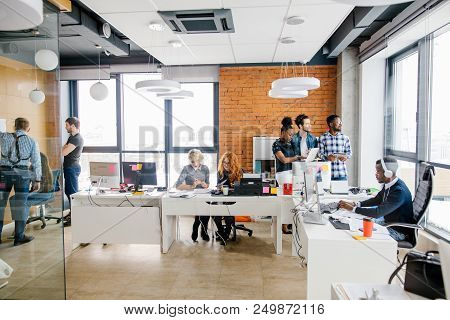 Two Office Workers Are Distracted By A Beautiful Girl Outdoor While Oher Partners Are Fulfiling Thei