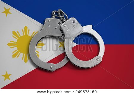 Philippines Flag  And Police Handcuffs. The Concept Of Observance Of The Law In The Country And Prot