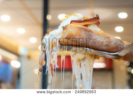Cutting Out A Piece Of Cheezy Pizza On A Knife