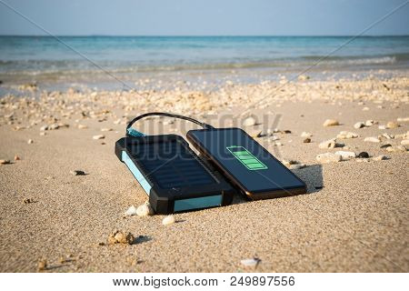 Frameless Smartphone Close Up On A Sandy Beach With Copy Space, The Concept Of Restoring Strength An