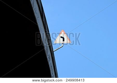 Triangle Turn Left Warning Sign Board On Highway Taken In Uprisen Angle View On A Clear Sky Day