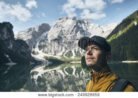 Young Man (tourist) In Nature. Mountains Refelection In Lake Braies, Italy.