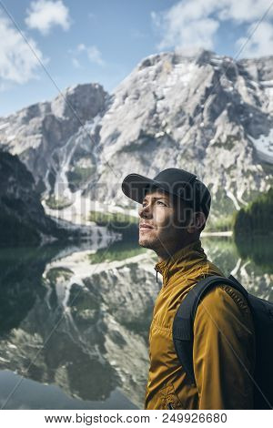 Young Man (tourist) In Nature. Mountains Refelection In Lake Braies, Italy.