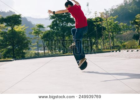 One Young Skateboarder Sakteboarding On Parking Lot