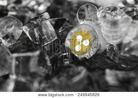 Gold Ripple Coin On Ice Background. The Concept Of The Exchange In Winter. Freeze. Blockchain Mining