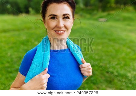 Elderly Female Doing Fitness Exercises Outdoor. Heathy Life Style Concept. Copyspace.