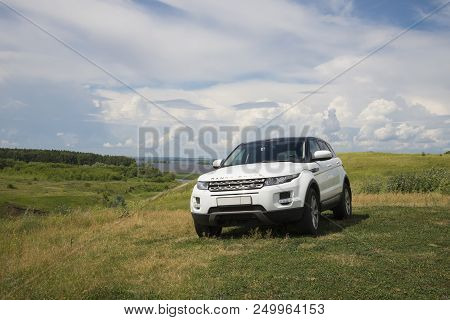 Car Land Rover Range Rover Is Standing At Green Grass At Summer Day Near The City Of Chistopol, Tata