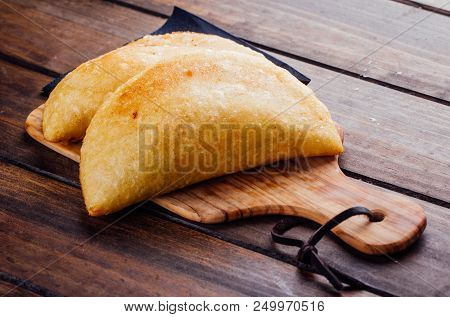 Typical Breakfast In Latin American Countries, Fried Empanadas On Wood Background