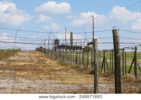 Majdanek, Poland,  2018-07-07. Barbed Wire Entanglements And Crematorium Of The Former Nazi German C