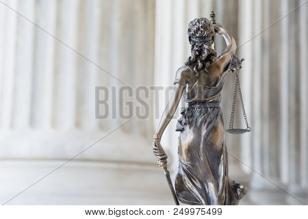 The Statue Of Justice Themis Or Iustitia, The Blindfolded Goddess Of Justice Against An Ionic Order 