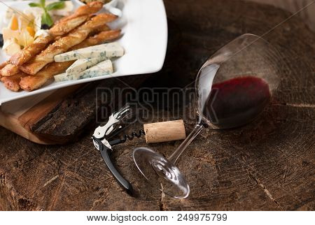 Red Wine In Wine Glass With Corkscrew And Cheese On Wooden Background. With Space For Text, Selectiv