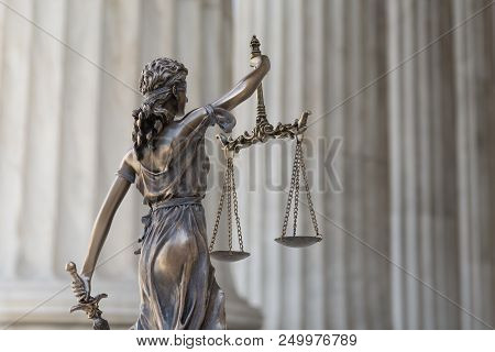 The Statue Of Justice Themis Or Iustitia, The Blindfolded Goddess Of Justice Against An Ionic Order 