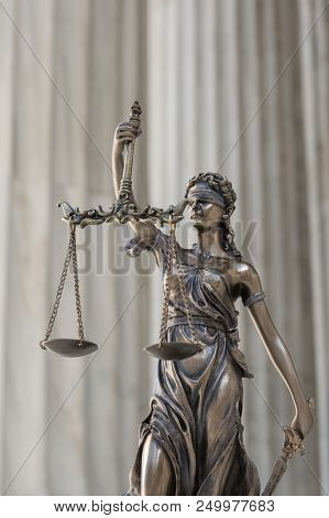 The Statue Of Justice Themis Or Iustitia, The Blindfolded Goddess Of Justice Against An Ionic Order 