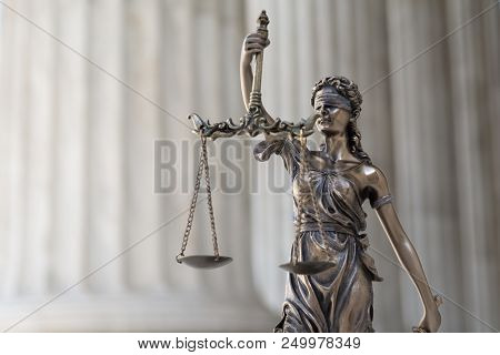 The Statue Of Justice Themis Or Iustitia, The Blindfolded Goddess Of Justice Against An Ionic Order 